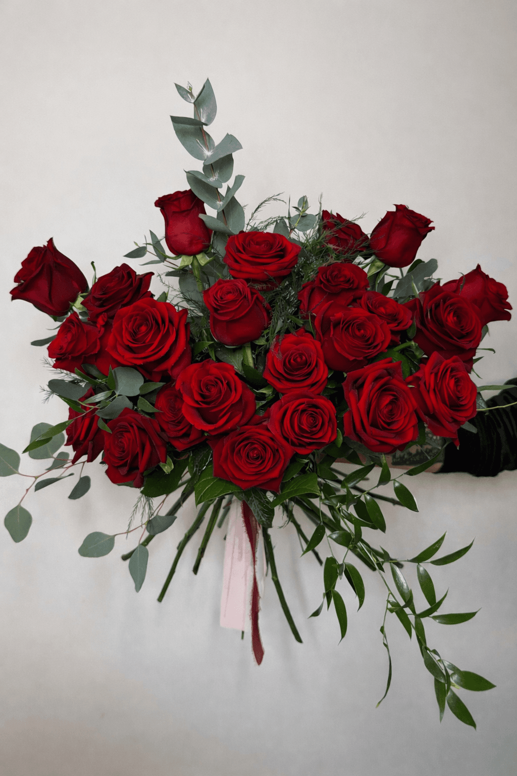 Hand-tied bouquet of premium red roses by Flora & Fable